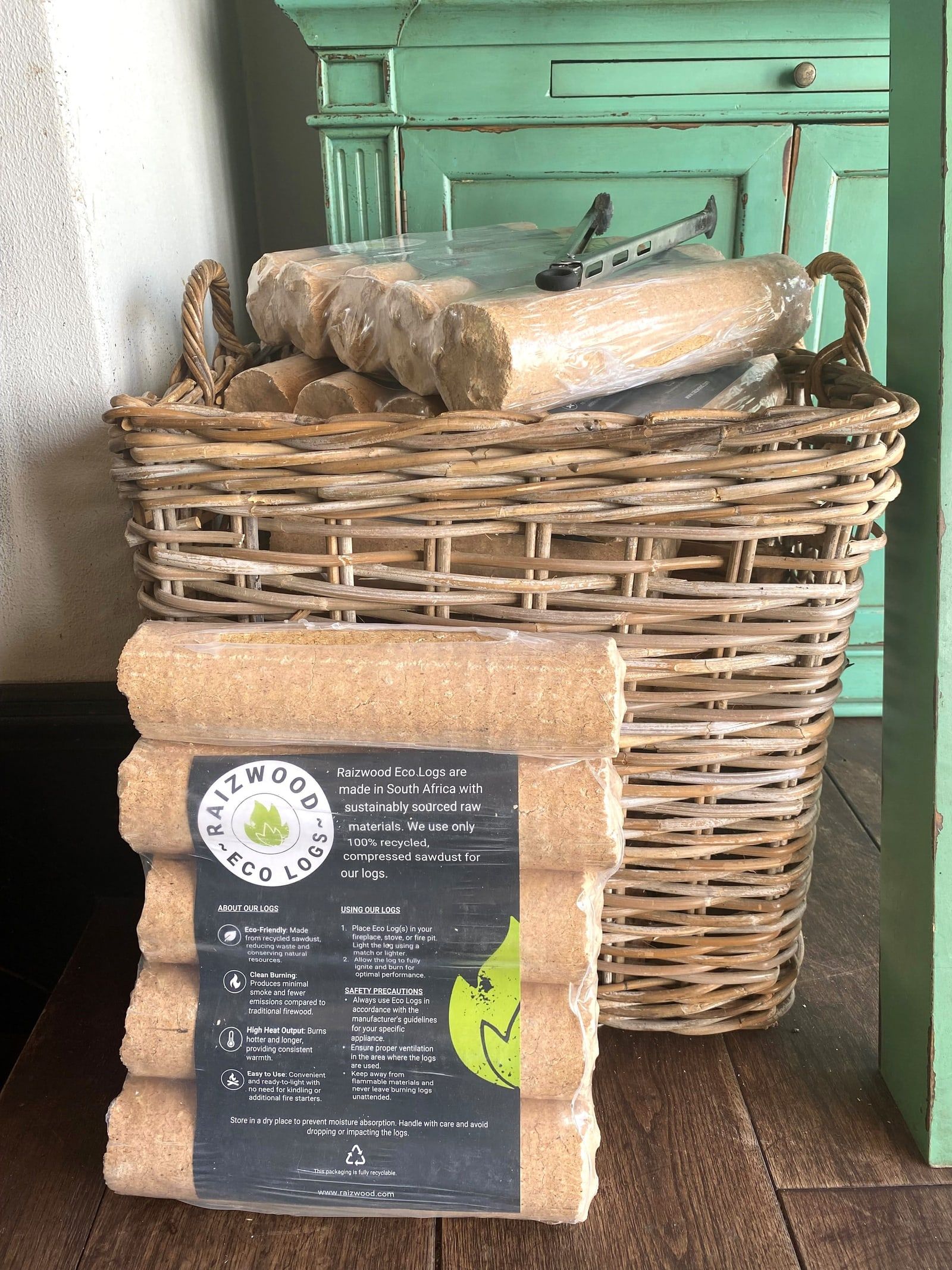 A pack of Raizwood Eco Logs leaning against a basket filled with eco logs