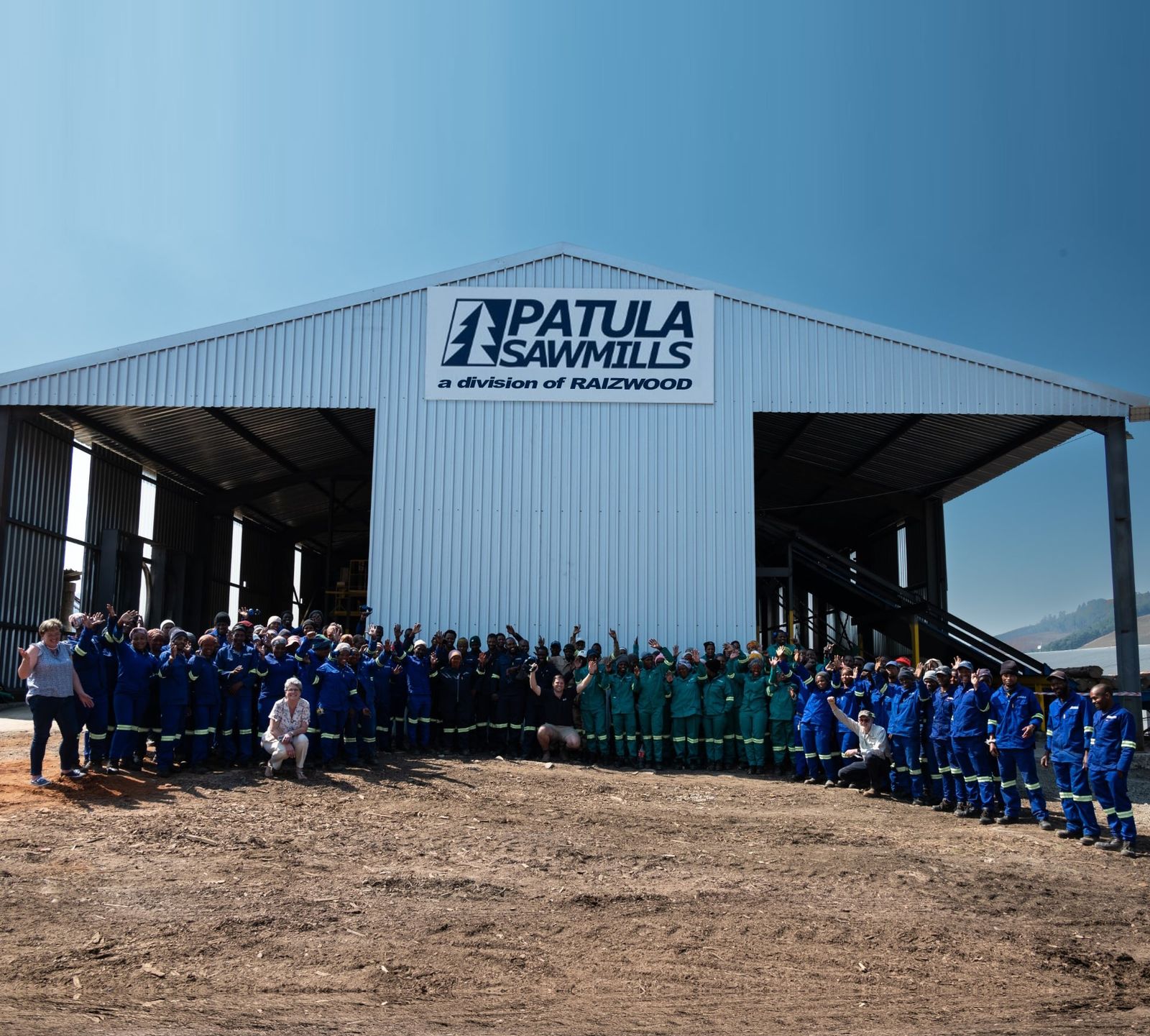 The Raizwood team in front of the Patula Sawmills building, a division of Raizwood